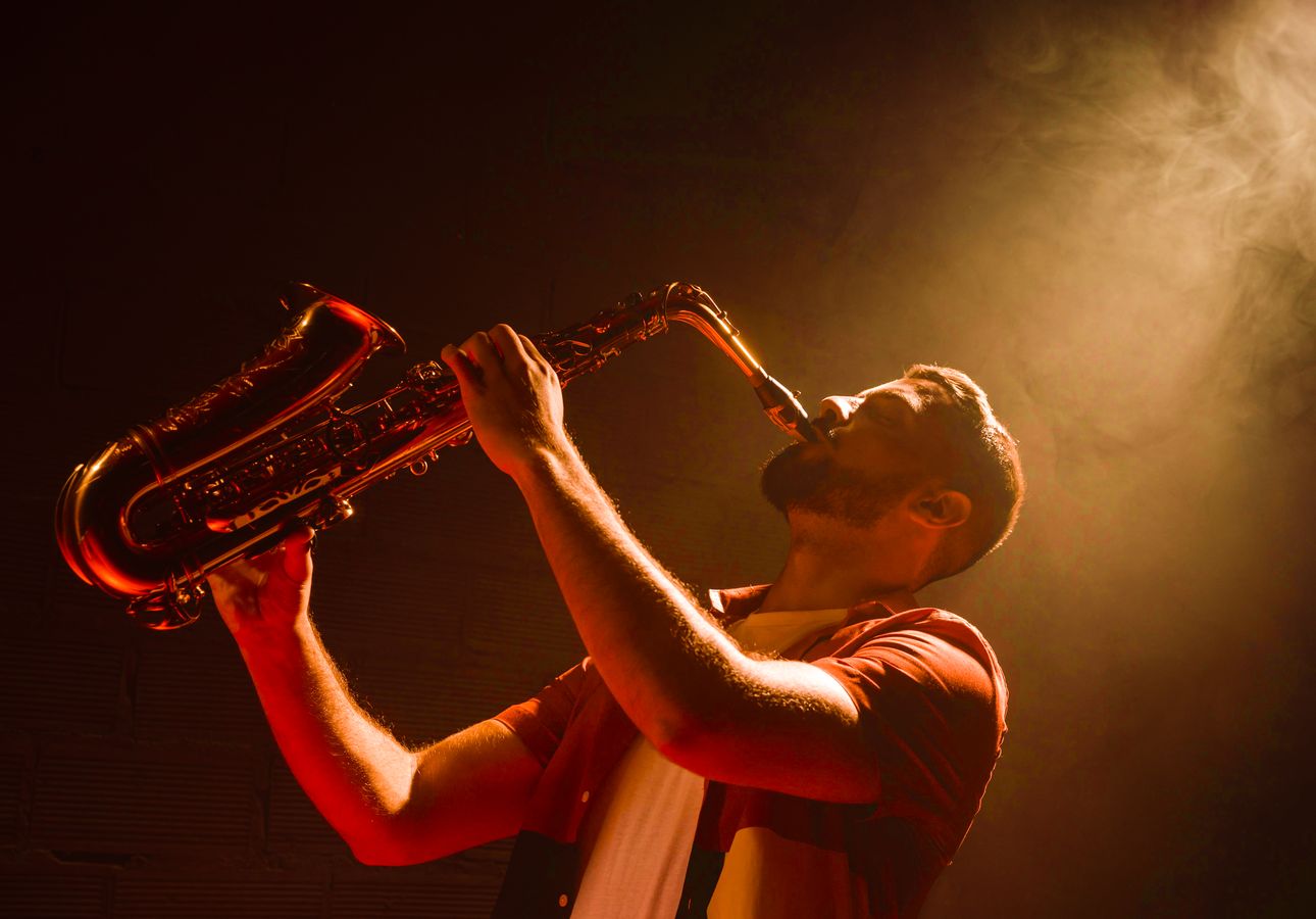 man playing the saxophone in spotlight2